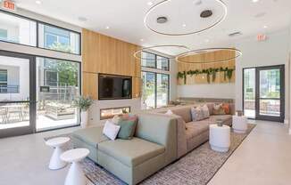 A living room with a grey couch and a television.