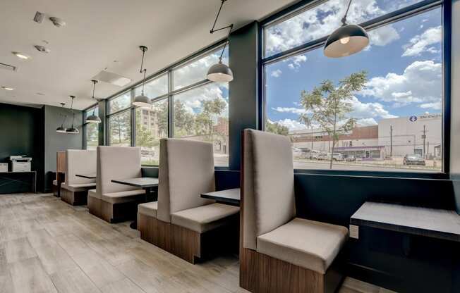 a seating area with chairs and a table in front of a window