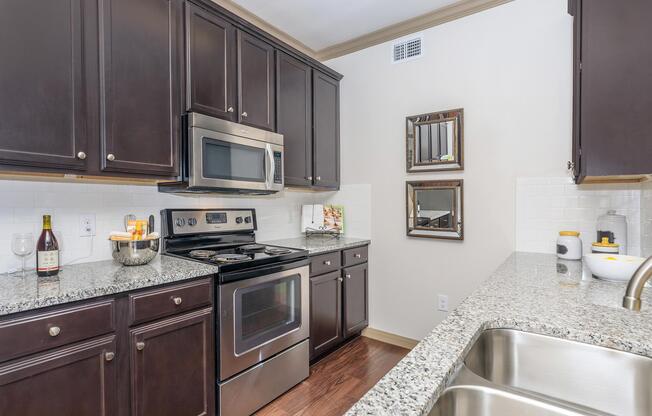 a kitchen with stainless steel appliances and wooden cabinets