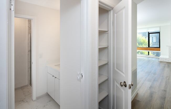 a bedroom with a medium sized bed and a mirror on the wall