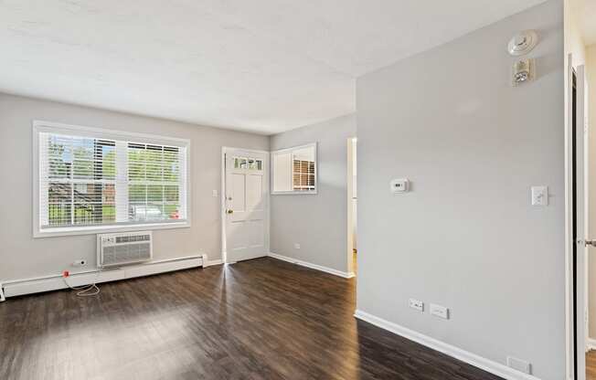a bedroom with hardwood floors and grey walls at The Hinsdale, Illinois