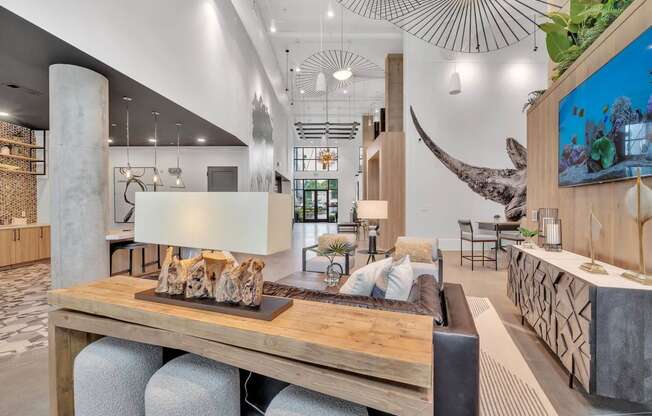 a living room with a wooden table and a whale painting on the wall