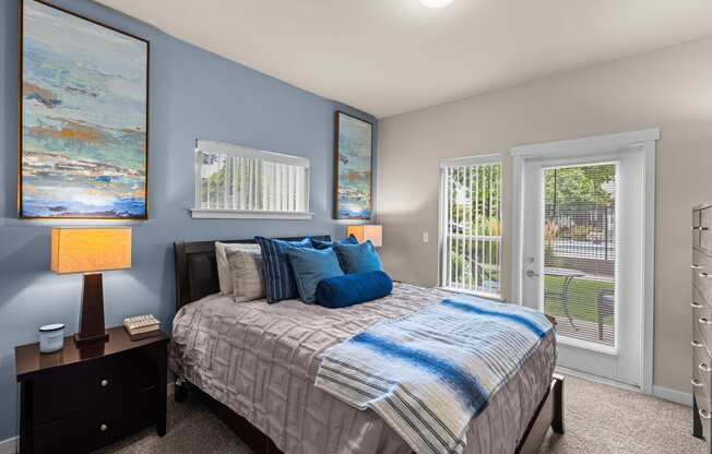 a bedroom with a bed and two windows