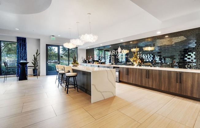 A modern kitchen with a bar area and a dining table.