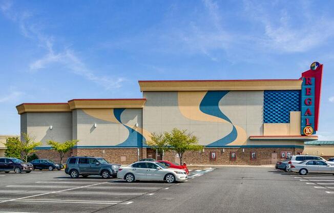 an empty parking lot in front of a building with a sign