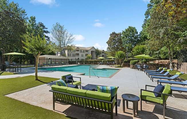 Community Swimming Pool with Pool Furniture at Retreat at Stonecrest Apartments located in Lithonia, GA.