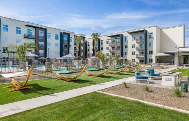 Open green spaces with hammock lounge at Glen 91 Apartments in Glendale, AZ