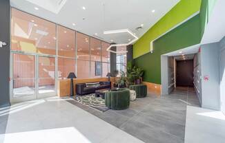 A modern interior with a glass wall and a green accent wall.