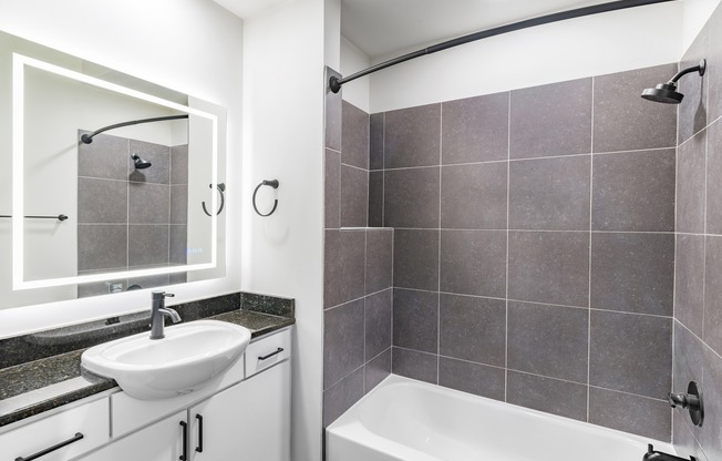 Serene bathrooms featuring LED backlit mirrors.