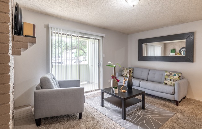 a living room with a couch and a chair and a table