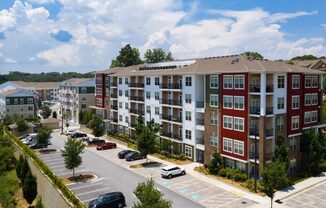 an aerial view of an apartment building in a parking lot