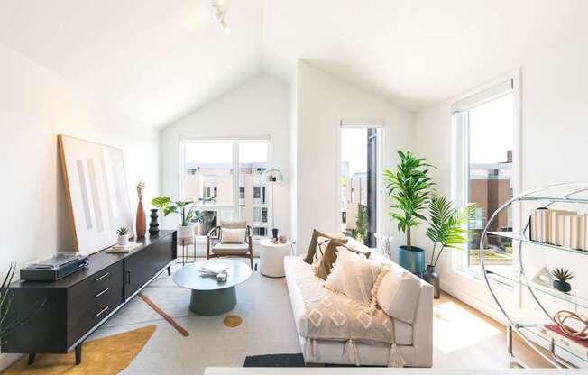 A living room with a white couch and a coffee table.