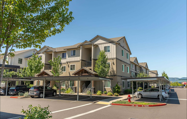 A row of houses with a car parked in front of them at Forestplace Apartment Homes, Forest Grove, OR, 97116