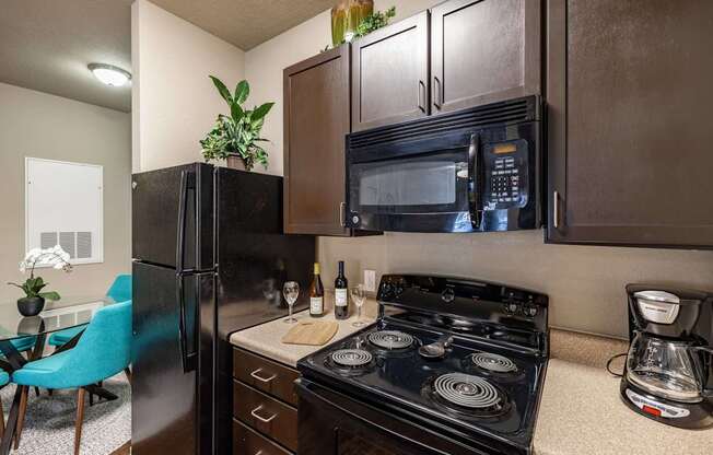 Big oaks apartments lakeland florida model kitchen with black appliances and wooden cabinets