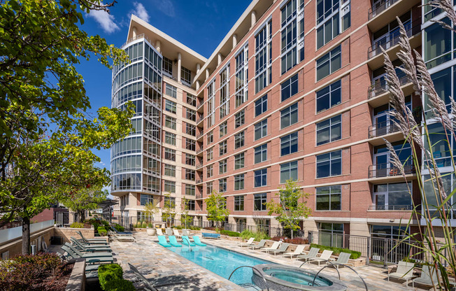 A large building with a pool in front of it.