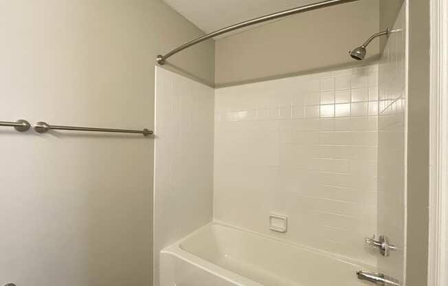 a bathroom with a shower and a bath tub