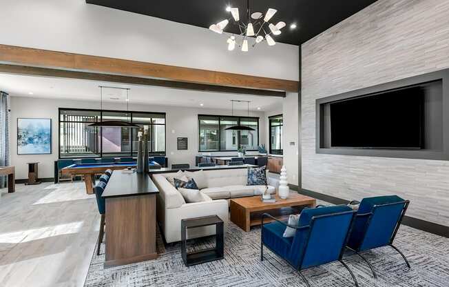 A modern living room with a pool table and a television.