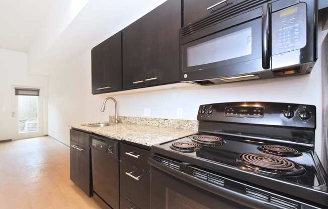 kitchen in a bedroom plus den unit.