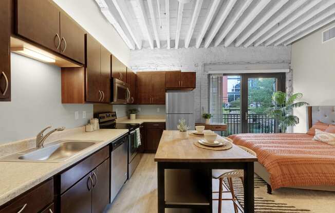 a kitchen with wooden cabinets and a wooden table