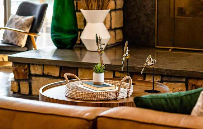 A living room with a brown leather couch and a woven coffee table.