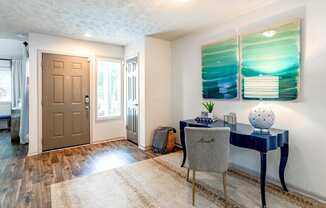 a home office with a desk and chair and a door