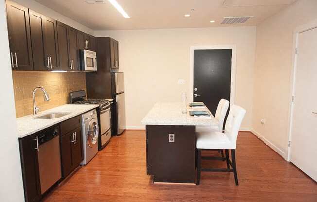 a kitchen with a stove top oven next to a sink
