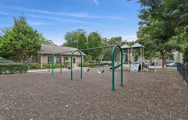 A playground with a swing set and a slide.