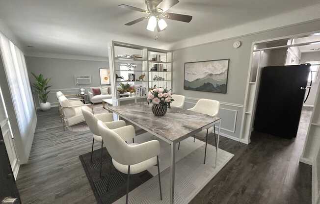 A dining room with a table and chairs.
