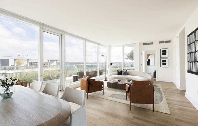 a living room filled with furniture and a large window