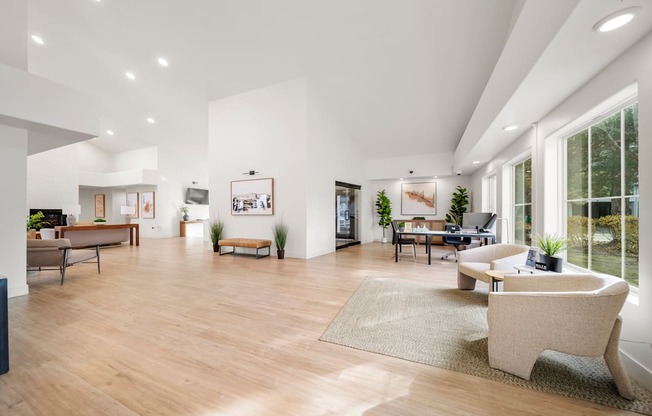 A spacious living room with a large window and a couch.