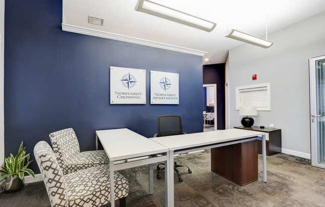 a conference room with a white table and chairs and a blue wall