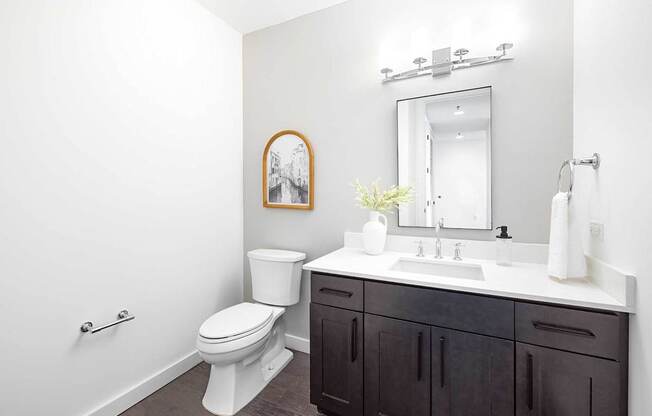 A white toilet sits next to a sink in a bathroom.