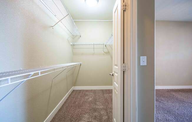 a walk in closet in a bedroom plus bedroom At Metropolitan Apartments in Little Rock, AR