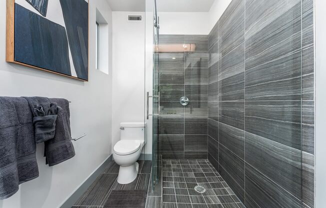 a bathroom with a toilet and a glass shower