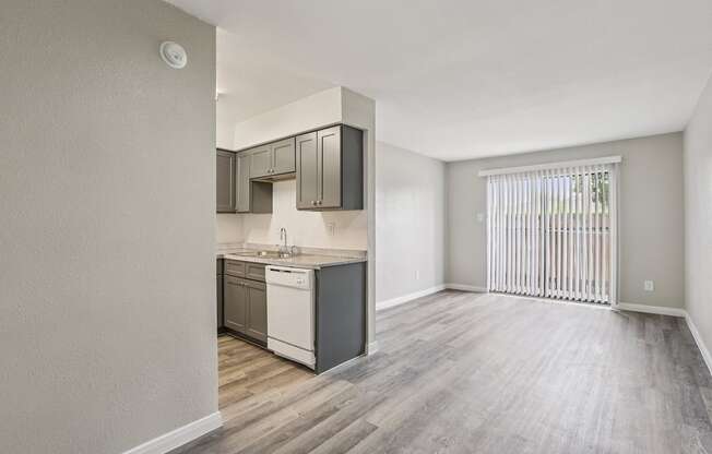 A kitchen with a white dishwasher and a white fridge.