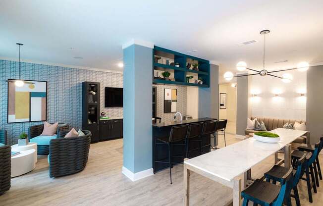 A modern dining room with a white table and chairs.
