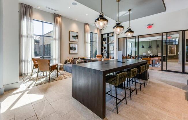 A modern kitchen with a bar area and a dining table.