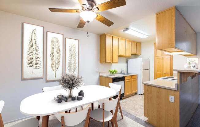 A white dining table with four chairs and a ceiling fan in a kitchen.
