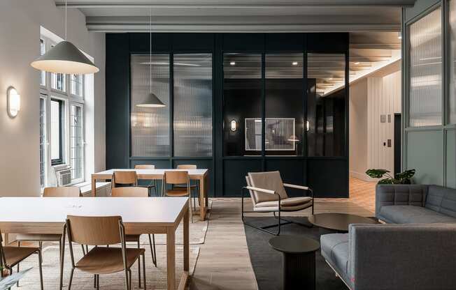 a dining room with tables and chairs and a living room