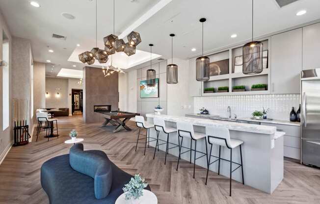 A modern kitchen with a bar area and a living room area.