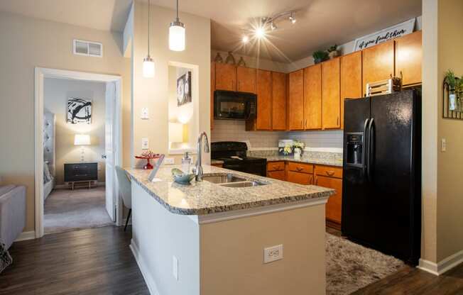 a kitchen with black appliances and granite counter tops