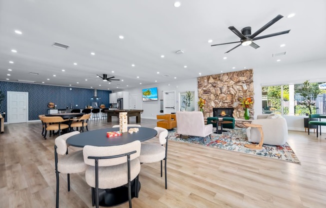 A modern living room with a fireplace and a dining table.