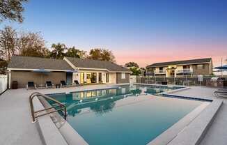 Community Swimming Pool with Pool Furniture at Arbors at Orange Park Apartments located in Orange Park, FL.