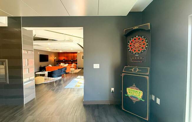 A room with a dart board on the wall.