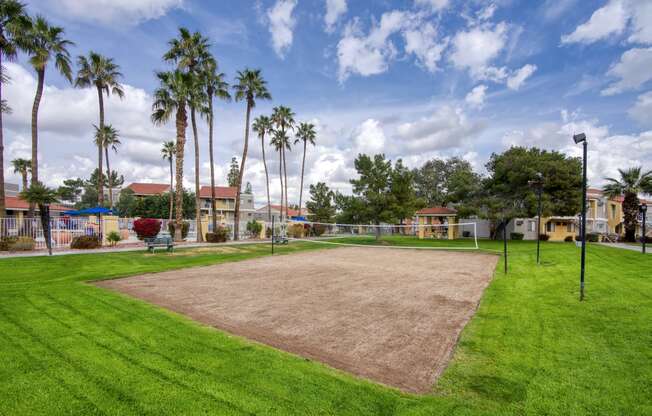 a baseball diamond with palm trees in the background