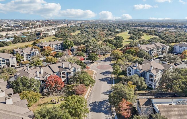 A bird's eye view of a residential area with houses and trees.
