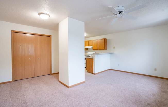 A room with a ceiling fan and a door. Fargo, ND Summit Point