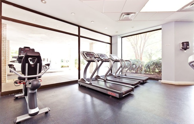 A gym with treadmills and exercise bikes.