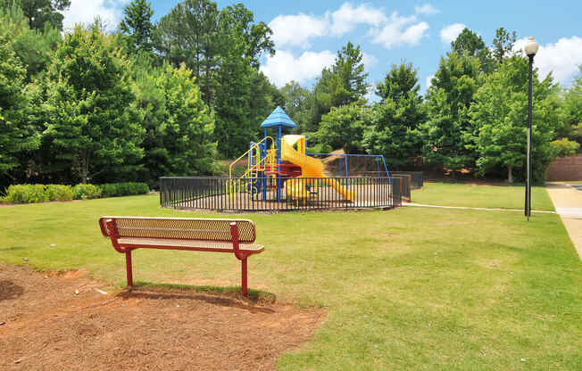 Playground with a park bench looking toward the playground equipment