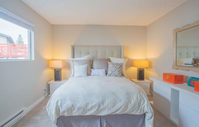 a white bedroom with a bed and a window at Sunnyvale Crossings Apartments, LLC, Sunnyvale, 94087